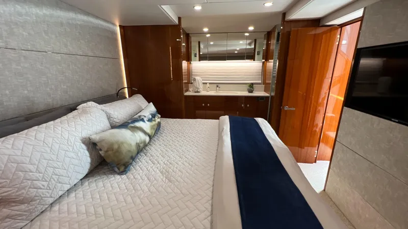 Slide: The Image of Luxurious bedroom interior of 2021 Maritimo X60 yacht with elegant bedding and wood finishes. - 33