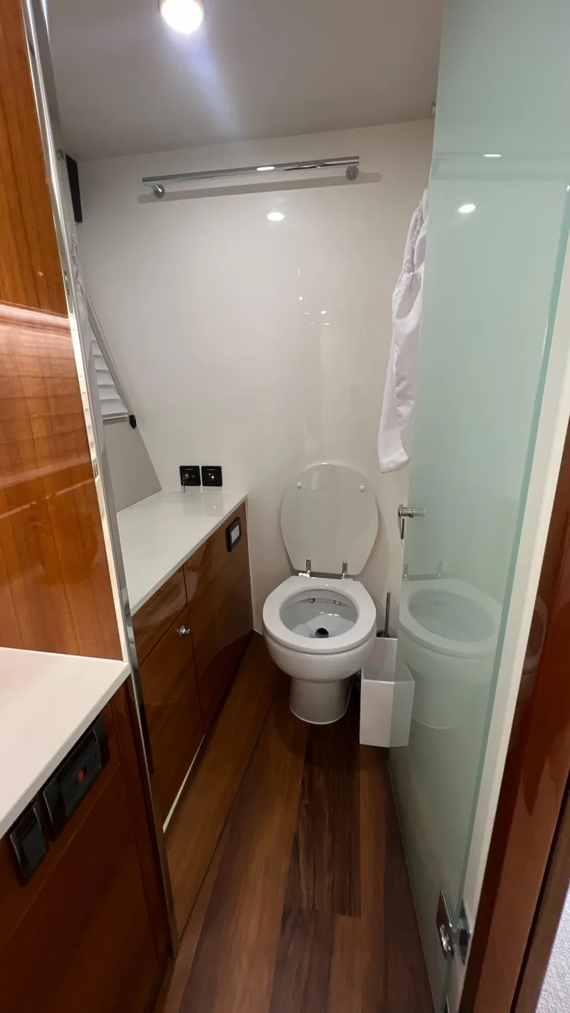 Slide: The Image of 2021 Maritimo X60 yacht bathroom with modern fixtures and wooden accents. - 36
