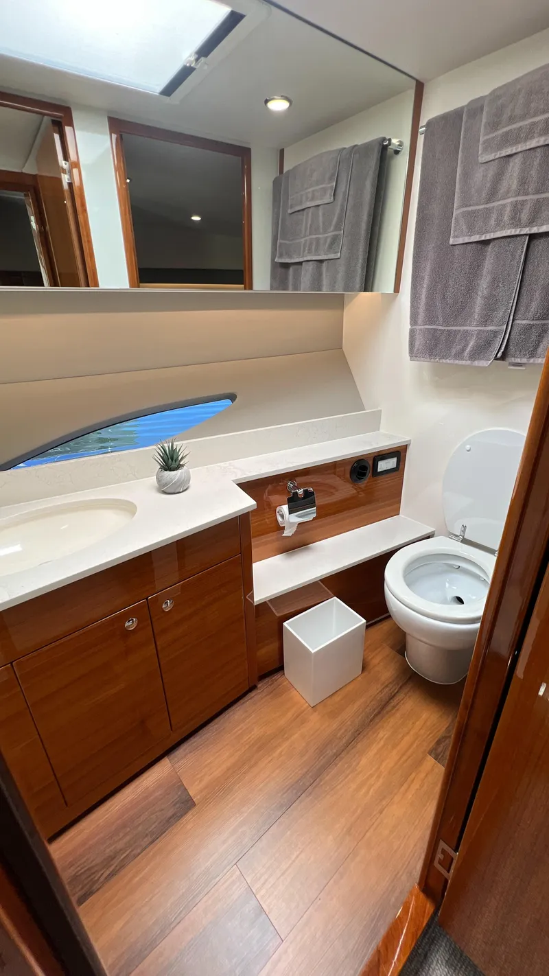 Slide: The Image of 2021 Maritimo X60 yacht bathroom with wood flooring, modern fixtures, and elegant design. - 38