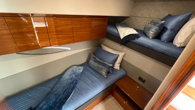 Slide: The Image of Luxurious cabin interior of 2021 Maritimo X60 yacht with cozy bedding and wooden accents. - 41