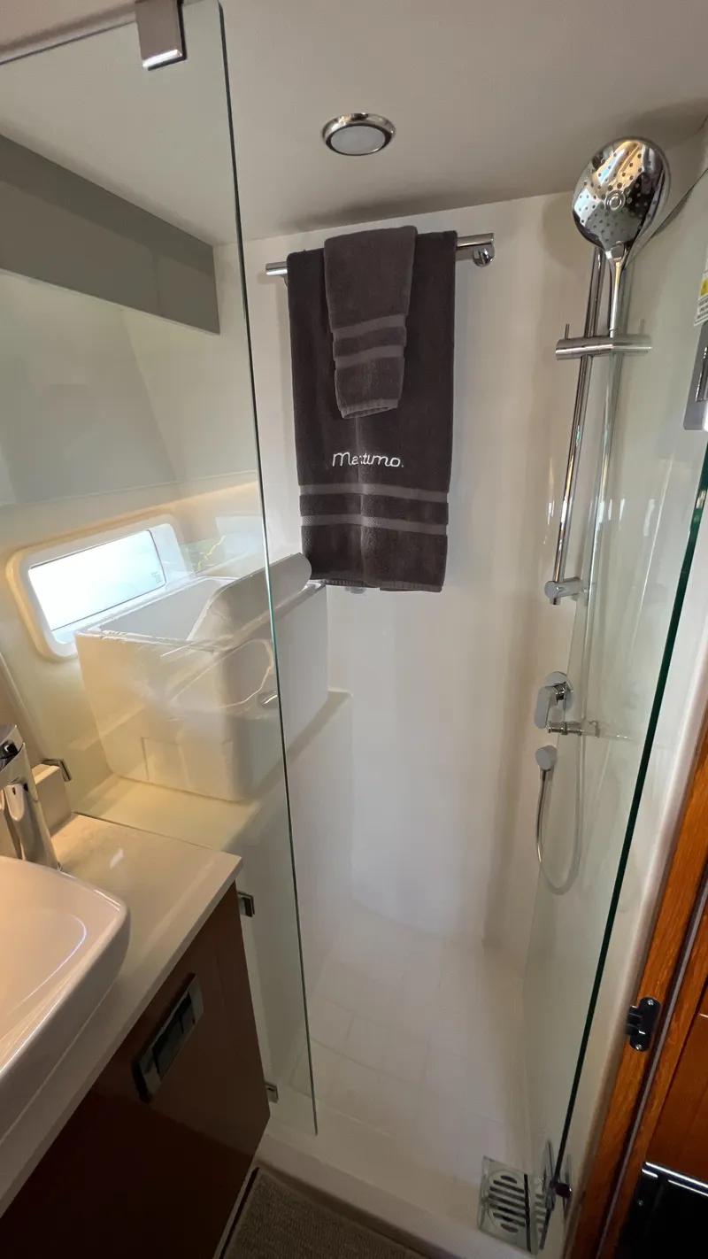Slide: The Image of 2021 Maritimo X60 yacht bathroom with shower, towel, and modern fixtures. - 45