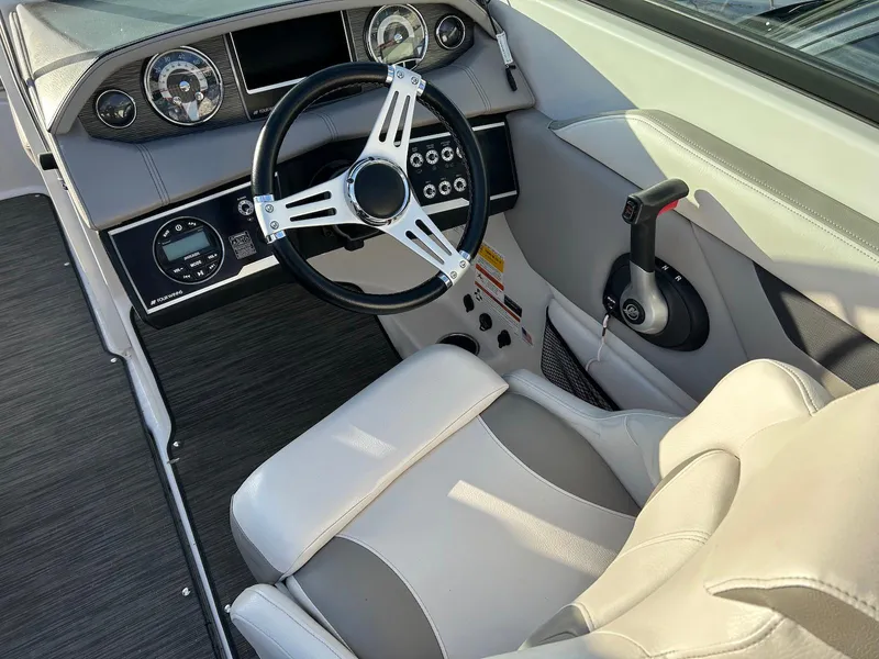 Slide: The Image of 2018 Four Winns HD220 boat cockpit with steering wheel and control panel. - 10