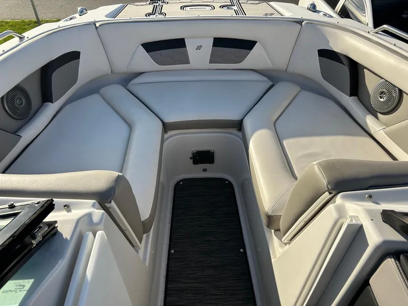 Slide: The Image of 2018 Four Winns HD220 boat interior with cushioned seating and speakers. - 13