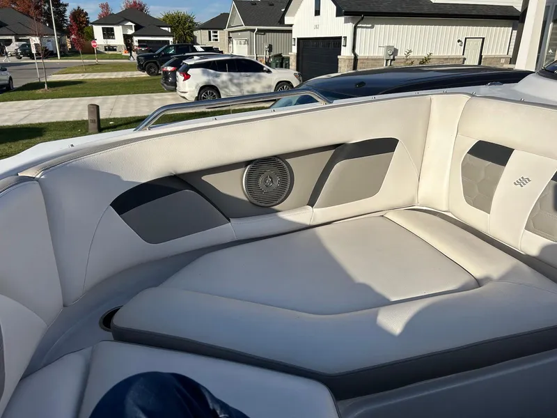 Slide: The Image of 2018 Four Winns HD220 boat interior with white and gray seating, outdoor setting. - 16