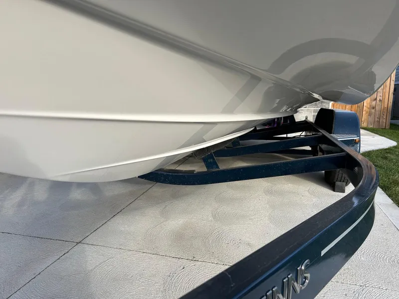 Slide: The Image of 2018 Four Winns HD220 boat on trailer, close-up view of hull and trailer. - 19