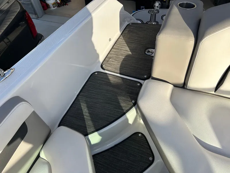 Slide: The Image of Interior seating of 2018 Four Winns HD220 boat with gray upholstery and black flooring. - 25
