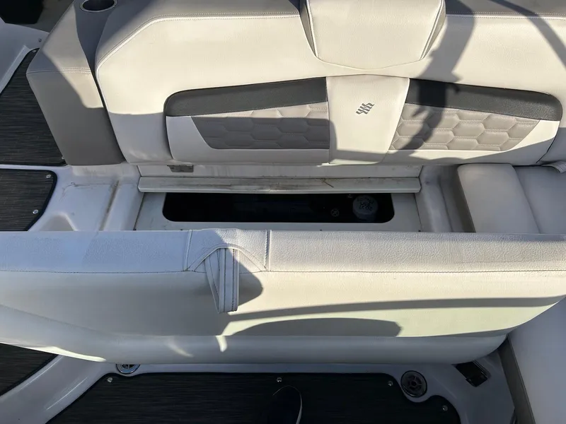 Slide: The Image of 2018 Four Winns HD220 boat interior with open storage compartment and cushioned seating. - 29