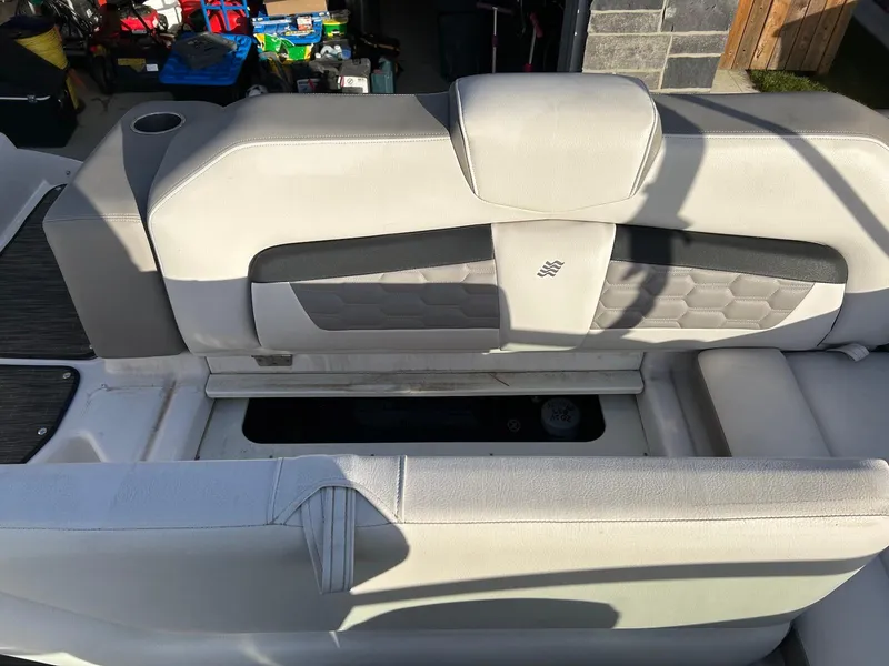 Slide: The Image of 2018 Four Winns HD220 boat seat with storage compartment, featuring light gray upholstery. - 30