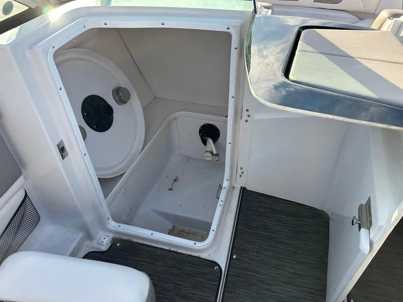 Slide: The Image of 2018 Four Winns HD220 boat storage compartment with open hatch and clean interior. - 32