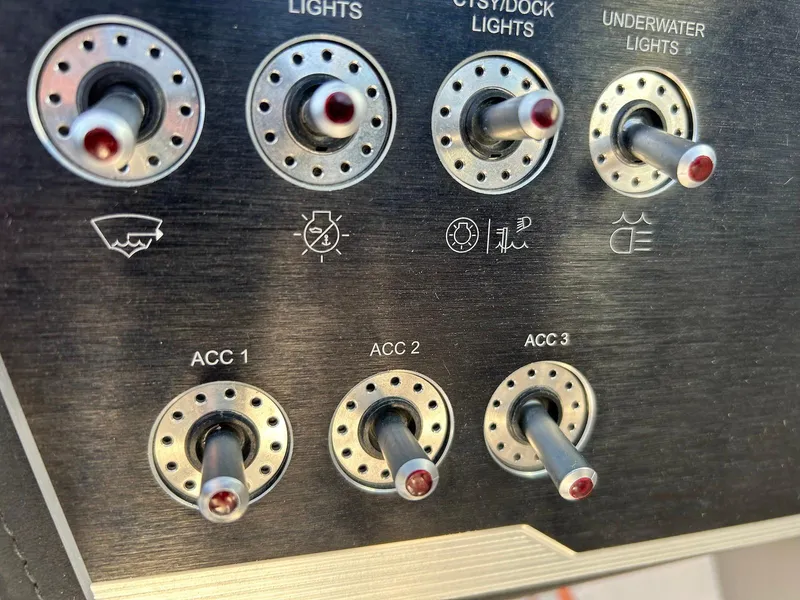 Slide: The Image of Control panel of a 2018 Four Winns HD220 boat with various light switches. - 37