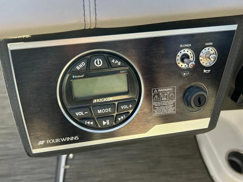 Slide: The Image of Control panel of a 2018 Four Winns HD220 boat with audio and blower controls. - 38