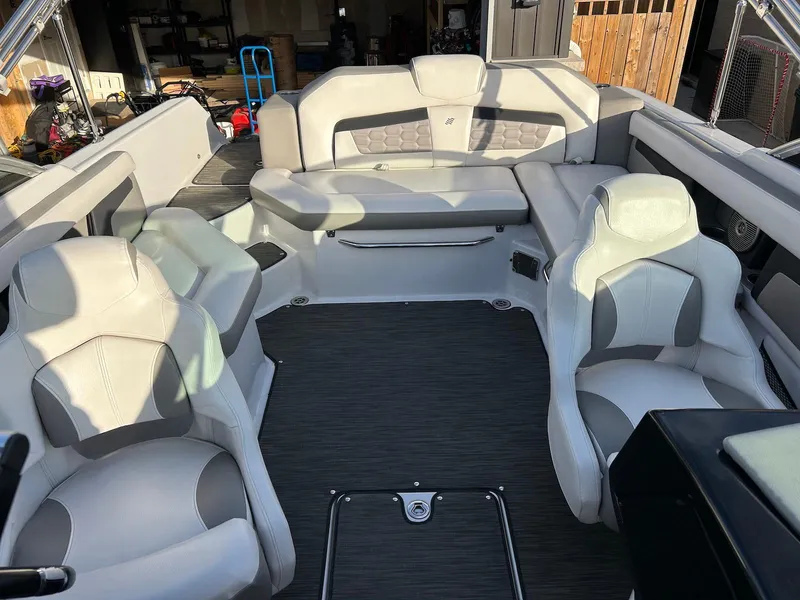 Slide: The Image of Interior of a 2018 Four Winns HD220 boat with spacious seating and modern design. - 7
