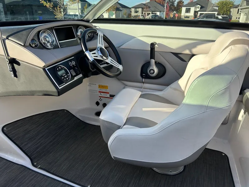 Slide: The Image of 2018 Four Winns HD220 boat interior with steering wheel and captain's seat. - 8