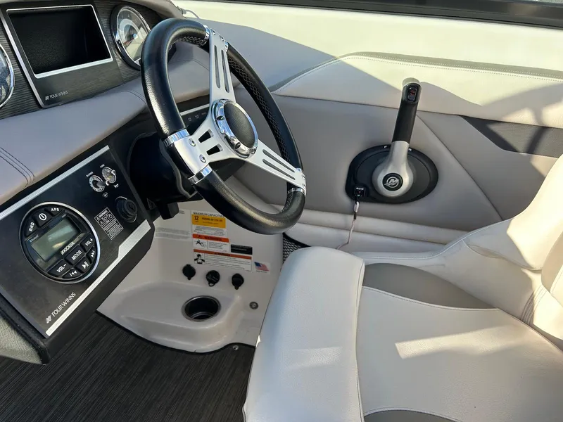 Slide: The Image of 2018 Four Winns HD220 boat interior with steering wheel and control panel. - 9