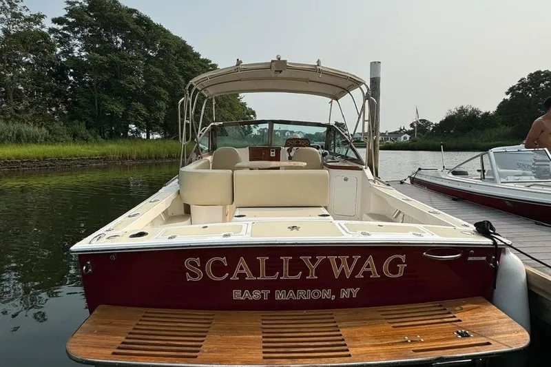 Slide: The Image of 2013 Hunt Yachts Harrier 25 boat interior with wooden dashboard and steering wheel. - 3