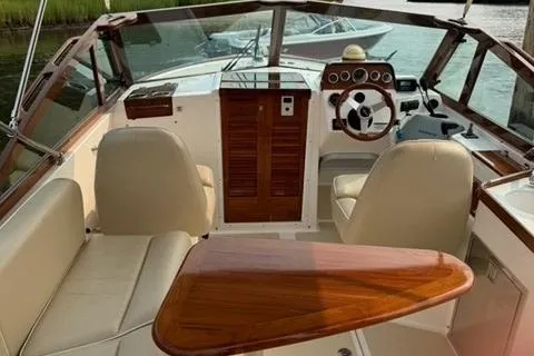 Slide: The Image of 2013 Hunt Yachts Harrier 25 interior with elegant wood finish and comfortable seating. - 5