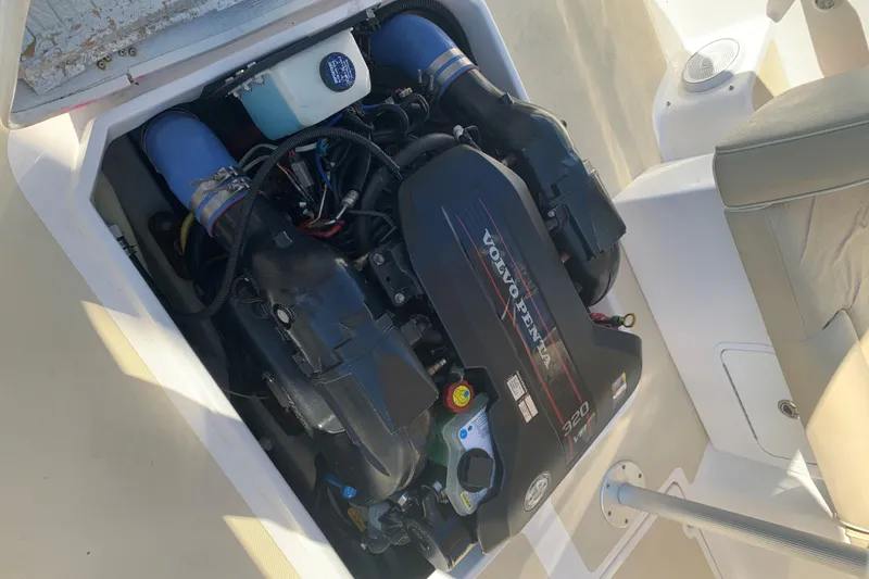 Slide: The Image of 2013 Hunt Yachts Harrier 25 in red, covered and lifted by a forklift. - 11