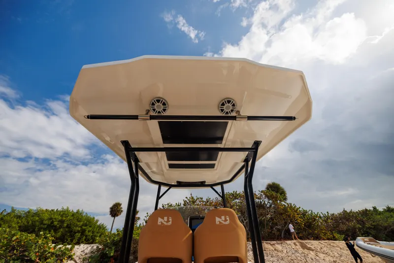 Slide: The Image of Nuova Jolly Prince 38 boat canopy, 2024 model, with speakers, under a partly cloudy sky. - 10