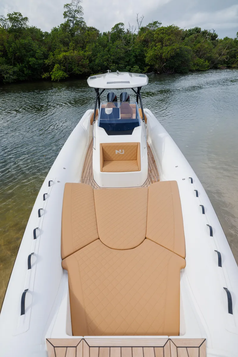 Slide: The Image of 2024 Nuova Jolly Prince 38 boat on calm water, featuring sleek design and spacious deck. - 16