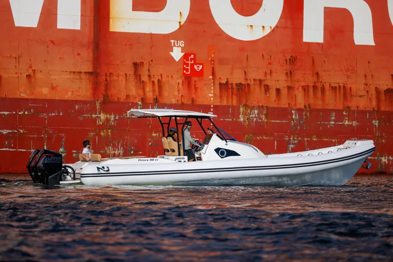 Slide: The Image of Nuova Jolly Prince 38 boat, 2024 model, cruising near a large ship. - 19