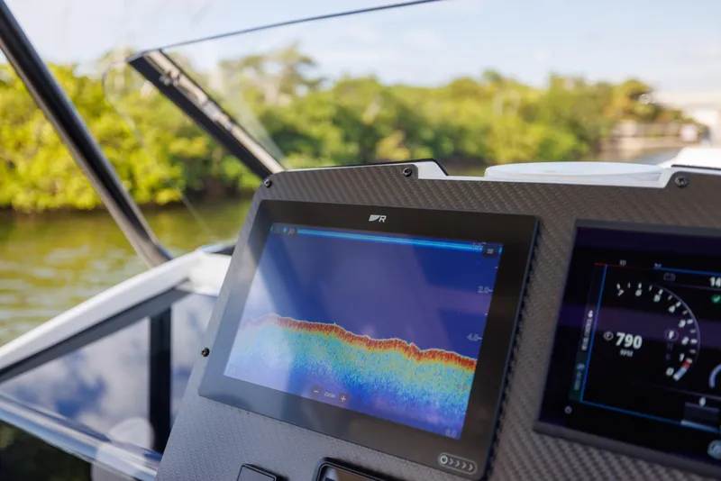 Slide: The Image of 2024 Nuova Jolly Prince 38 dashboard with navigation display, near lush greenery. - 26