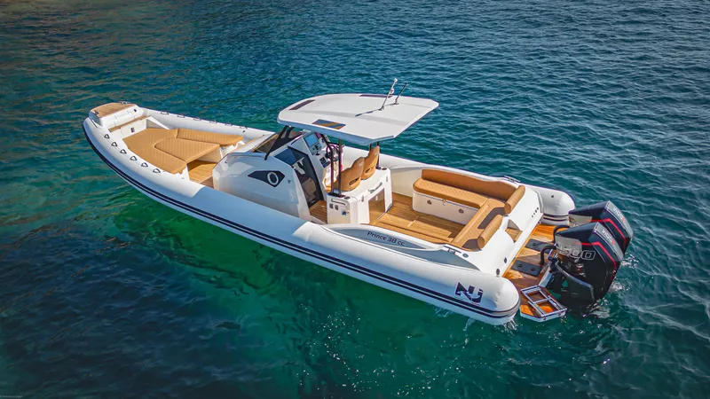 Slide: The Image of 2024 Nuova Jolly Prince 38 boat on clear blue water, featuring sleek design and twin engines. - 3