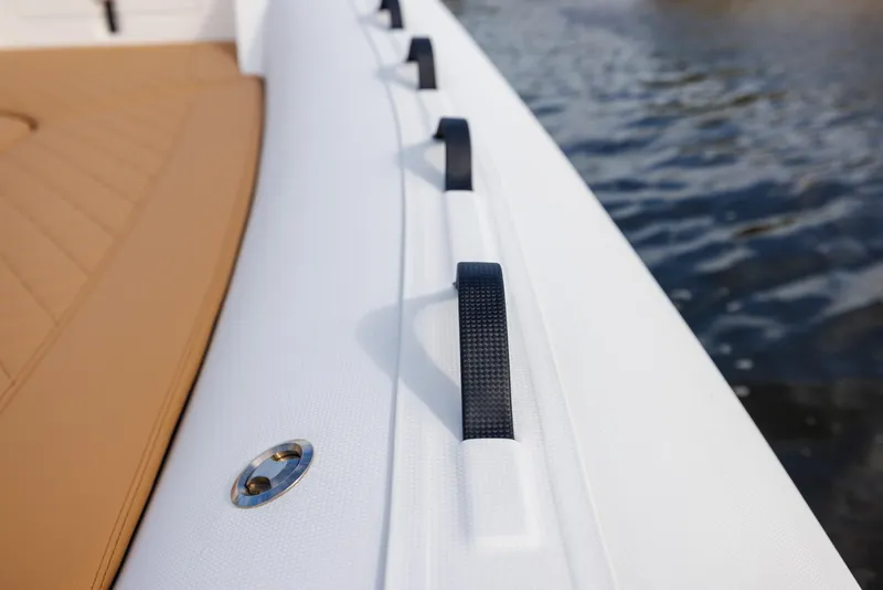 Slide: The Image of 2024 Nuova Jolly Prince 38 boat detail with white and tan design on water. - 31