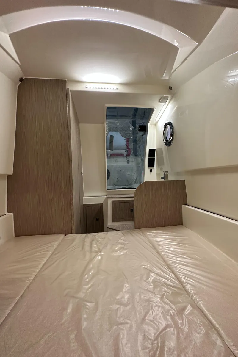 Slide: The Image of Interior cabin of 2024 Nuova Jolly Prince 38 boat, featuring modern design and wood accents. - 35