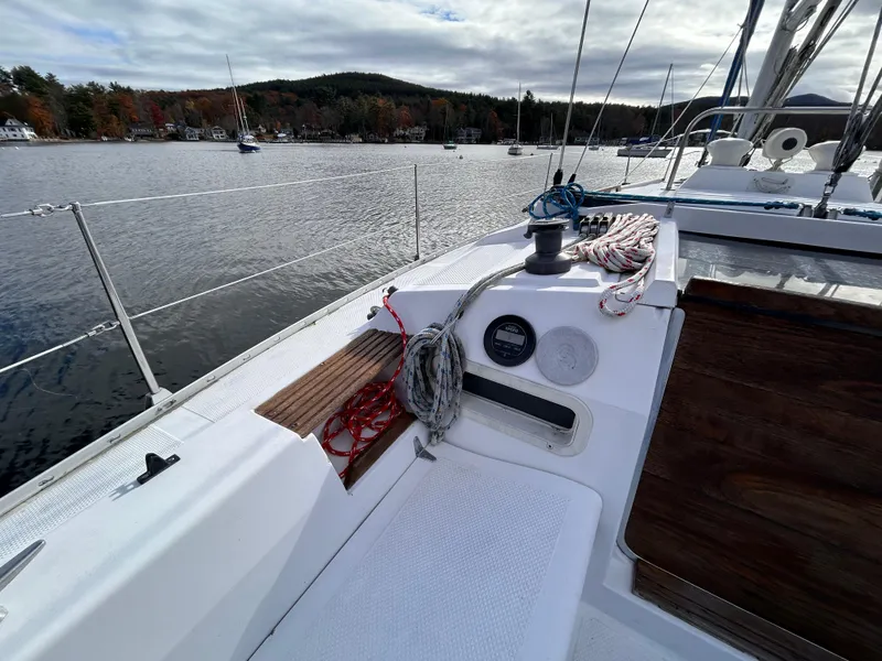 Slide: The Image of 1983 Hunter 34 sailboat deck with ropes, winch, and scenic lake view. - 14