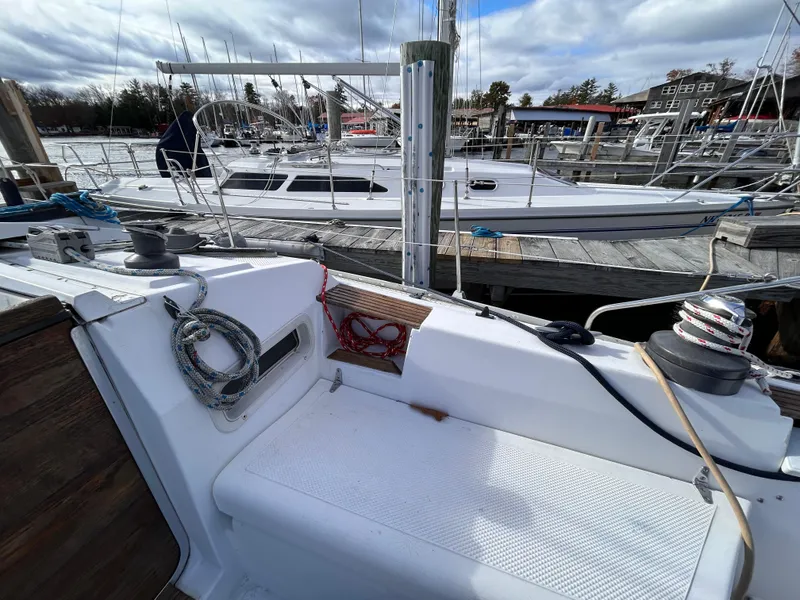 Slide: The Image of 1983 Hunter 34 sailboat docked at marina with other boats in background. - 15