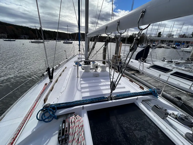 Slide: The Image of 1983 Hunter 34 sailboat deck with rigging, docked in a marina. - 18