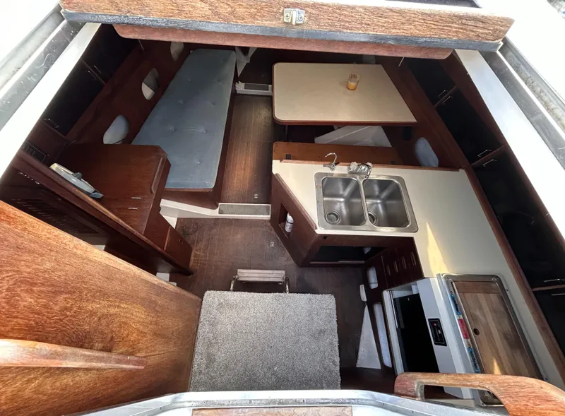 Slide: The Image of Interior of 1983 Hunter 34 sailboat with kitchen and seating area. - 28