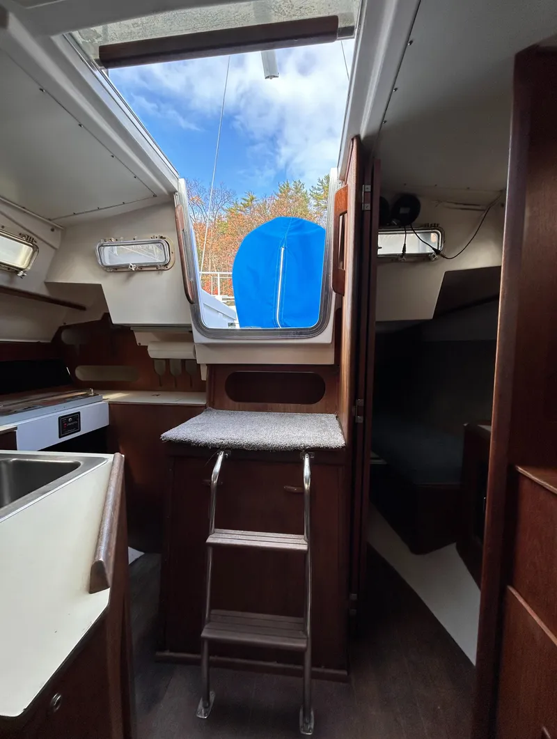 Slide: The Image of Interior of 1983 Hunter 34 sailboat with wooden cabinetry and compact kitchen area. - 29