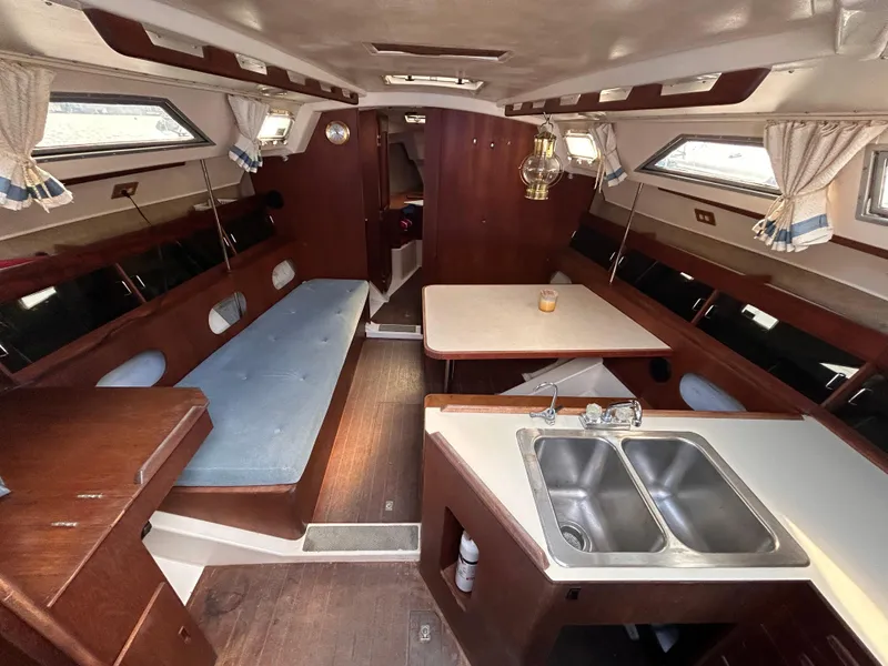 Slide: The Image of Interior of a 1983 Hunter 34 sailboat with wood finishes and seating area. - 31