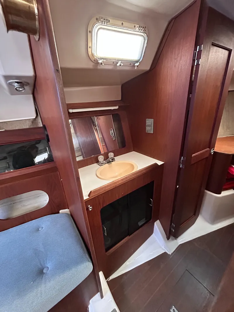 Slide: The Image of Interior of 1983 Hunter 34 sailboat with wooden cabinetry and compact sink area. - 39