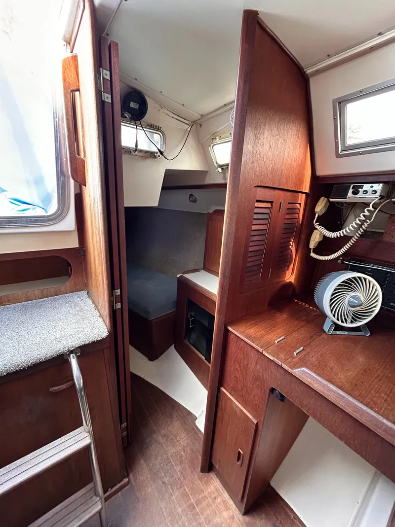 Slide: The Image of Interior of 1983 Hunter 34 sailboat with wood paneling and compact cabin layout. - 40