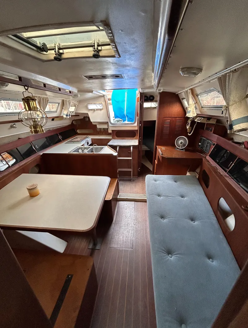 Slide: The Image of Interior of a 1983 Hunter 34 sailboat with seating, table, and wood accents. - 45