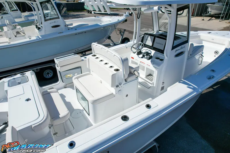 Slide: The Image of 2025 Sea Hunt Gamefish 27 boat interior with coffin box, featuring modern controls and seating. - 13