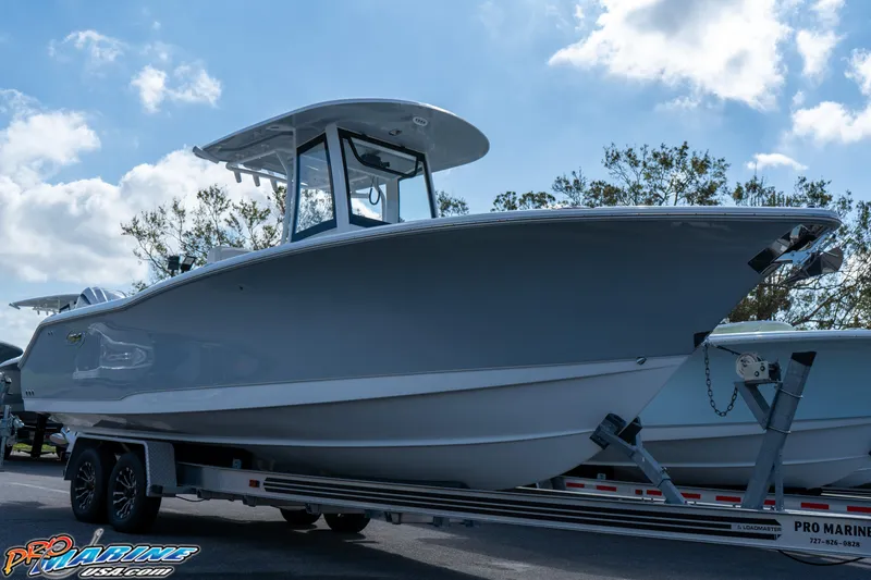 Slide: The Image of 2025 Sea Hunt Gamefish 27 boat on trailer, clear sky background. - 15