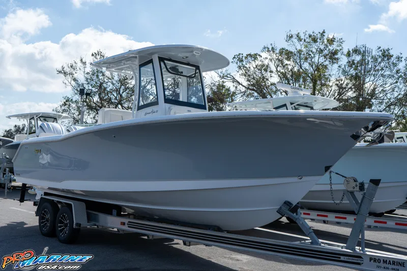 Slide: The Image of 2025 Sea Hunt Gamefish 27 with Coffin Box on trailer, displayed outdoors. - 16