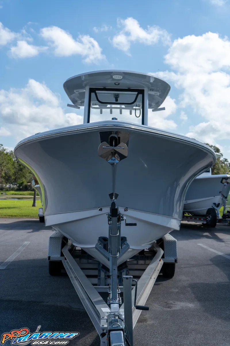 Slide: The Image of 2025 Sea Hunt Gamefish 27 with Coffin Box on trailer, front view under blue sky. - 17