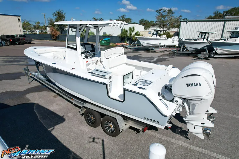 Slide: The Image of 2025 Sea Hunt Gamefish 27 with Coffin Box on trailer, featuring Yamaha outboard engines. - 2