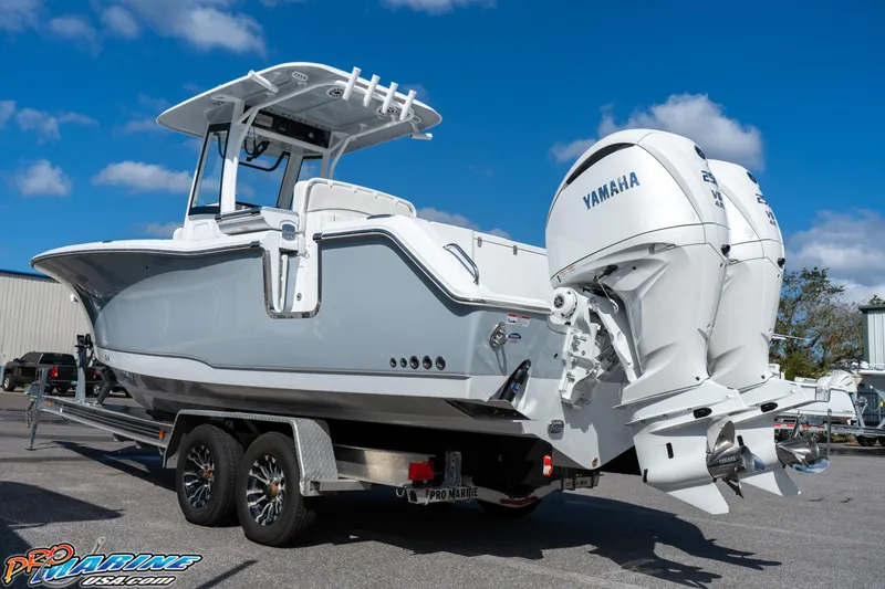 Slide: The Image of 2025 Sea Hunt Gamefish 27 boat with Yamaha engines on a trailer. - 21