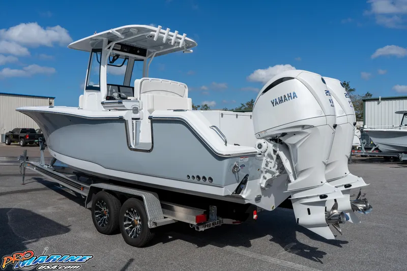 Slide: The Image of 2025 Sea Hunt Gamefish 27 boat with coffin box on trailer, featuring Yamaha engines. - 22