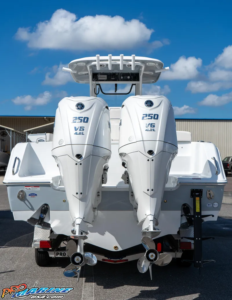 Slide: The Image of 2025 Sea Hunt Gamefish 27 with twin engines, rear view, under clear blue sky. - 25