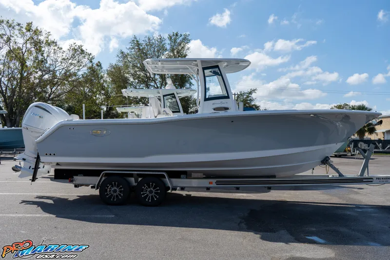 Slide: The Image of 2025 Sea Hunt Gamefish 27 with Coffin Box on trailer, parked outdoors. - 27