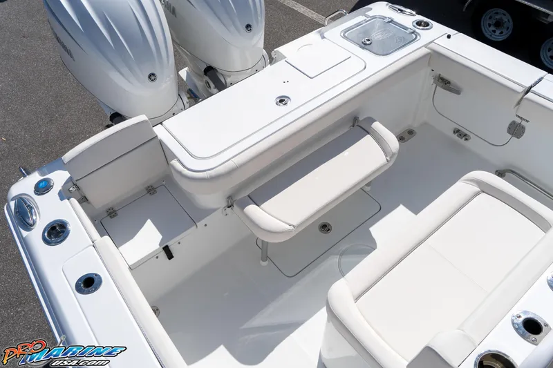 Slide: The Image of 2025 Sea Hunt Gamefish 27 boat interior with coffin box and dual engines. - 32