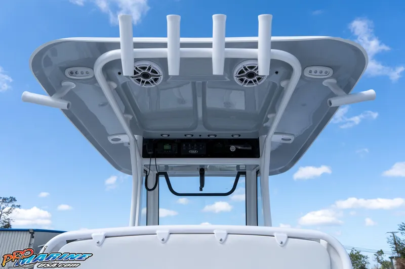 Slide: The Image of 2025 Sea Hunt Gamefish 27 boat with T-top and rod holders against blue sky. - 36