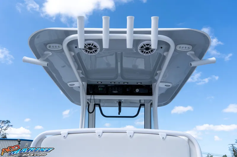 Slide: The Image of 2025 Sea Hunt Gamefish 27 T-top with rod holders against blue sky. - 37