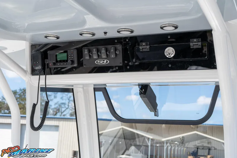 Slide: The Image of 2025 Sea Hunt Gamefish 27 console with electronics and storage. - 38